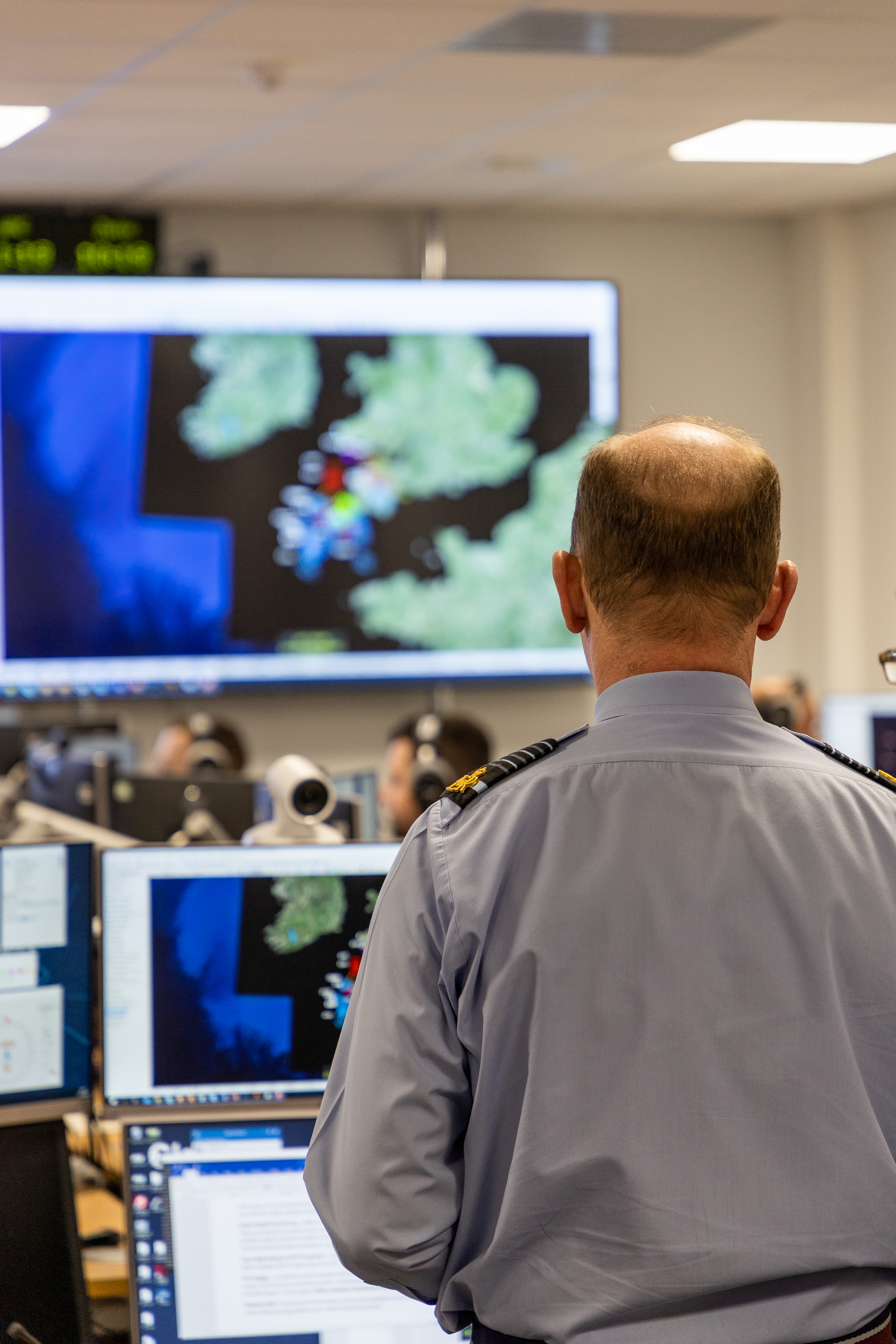 Image shows the Chief of the Air Staff looking at a large digital screen.